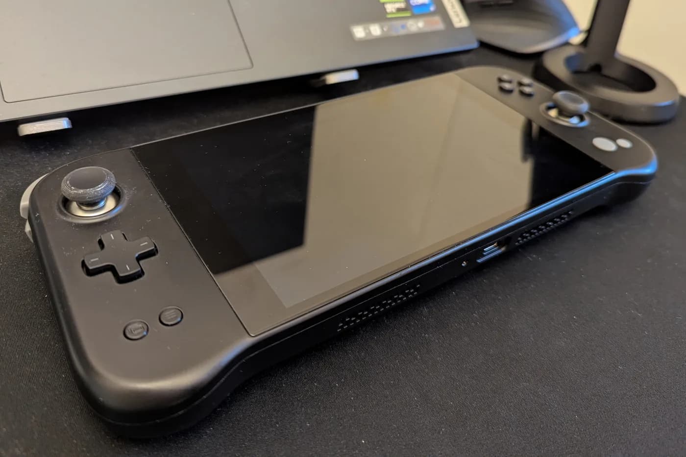 JOY Genesis prototype on a desk, showing the left stick, D-pad and screen